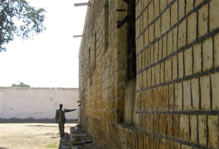 A prison guard stands near the wall of a prison in Berbera, Somaliland on March 27. Many of Somaliland's old prisons are overcrowded. There are 55 men to a cell at the prison in the port city of Berbera. The prison was built more than 100 years ago by the Turkish Ottoman empire.